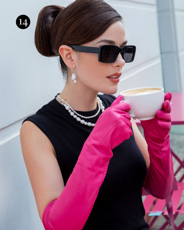 Woman wearing long leather gloves in sorbet drinking on a coffee outside a cafe