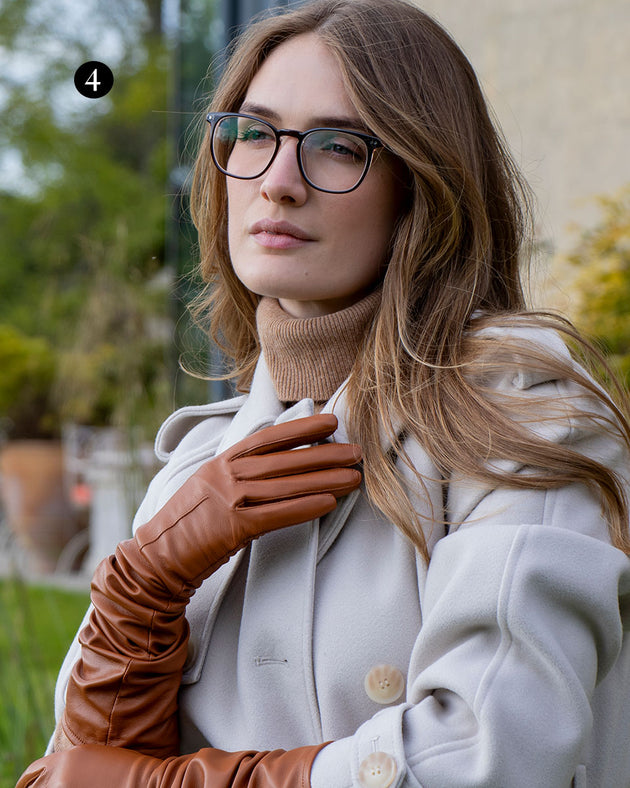 Woman wearing cognac long above elbow lined leather gloves