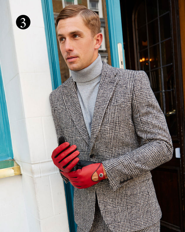 Man wearing leather gloves in fireball in the city