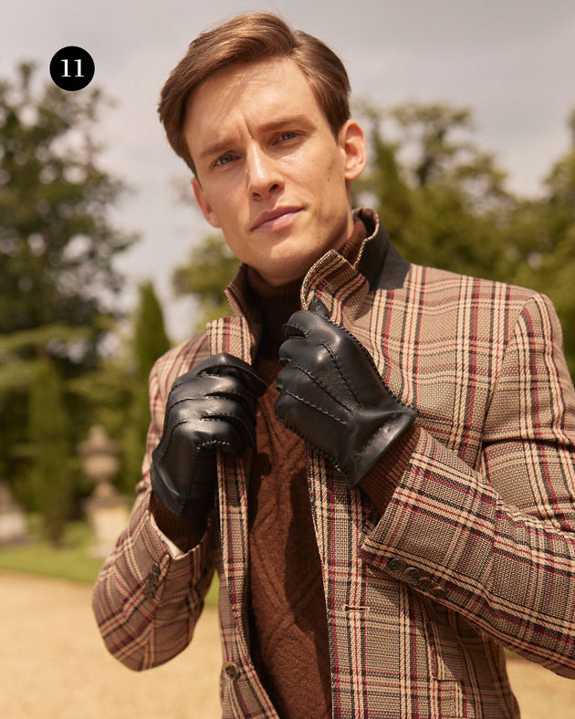 Man wearing leather cashmere lined leather gloves walking in the park