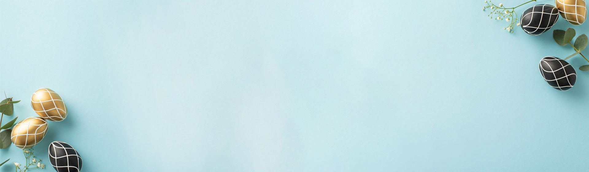 Blue background with black and gold eggs with white flowers. 