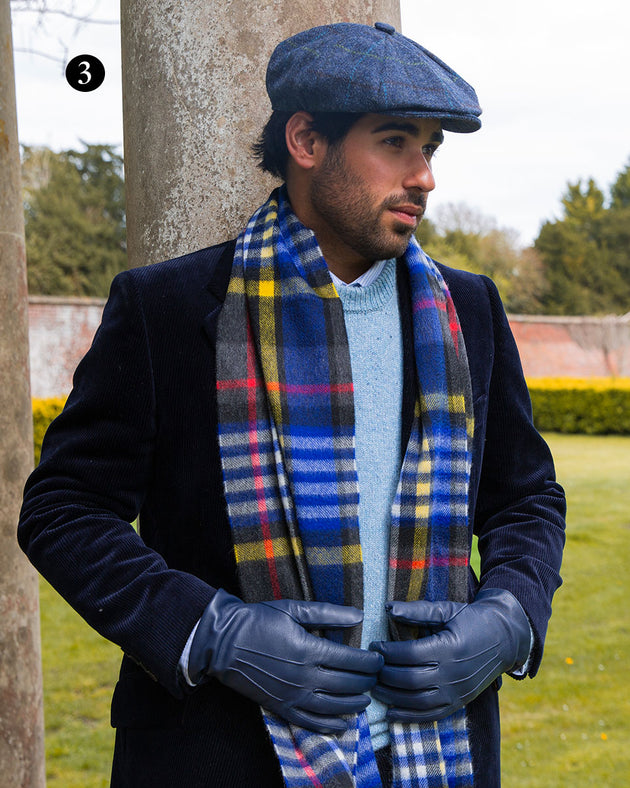 Man wearing heritage bold check cashmere scarf with tassels in night sky in park