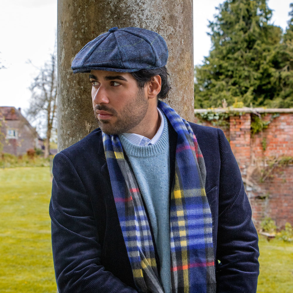 Man wearing check tweed newsboy cap in blue with cashmere scarf and corduroy jacket