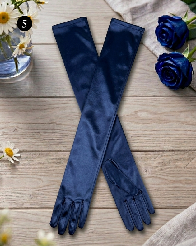 Women's long satin gloves in navy on a flatlay table with flowers.